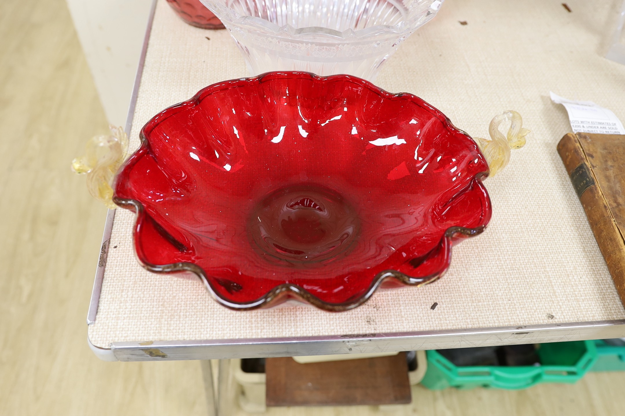 An abstract glass plant pot holder, together with a pair of cranberry glass jars and covers, etc.